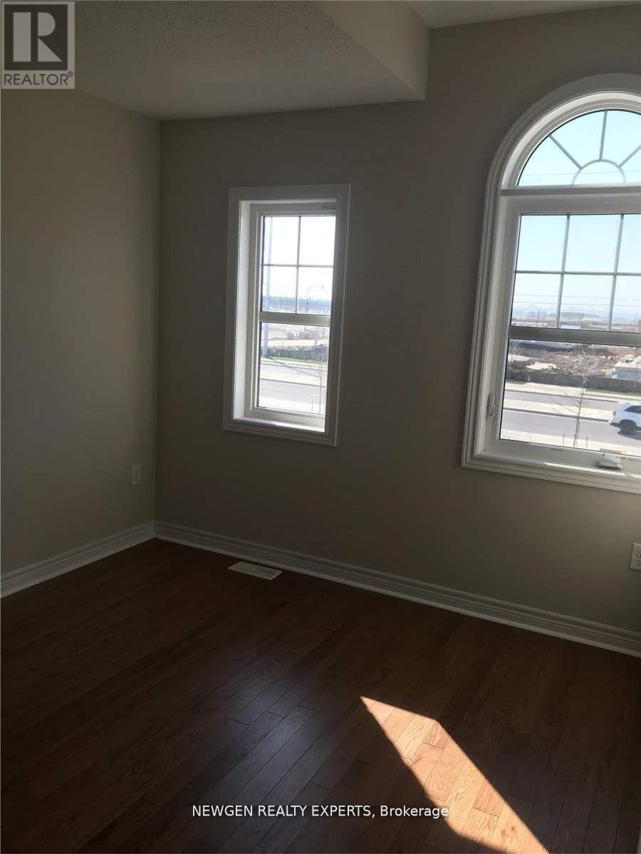 A room with a large window and a wooden floor.