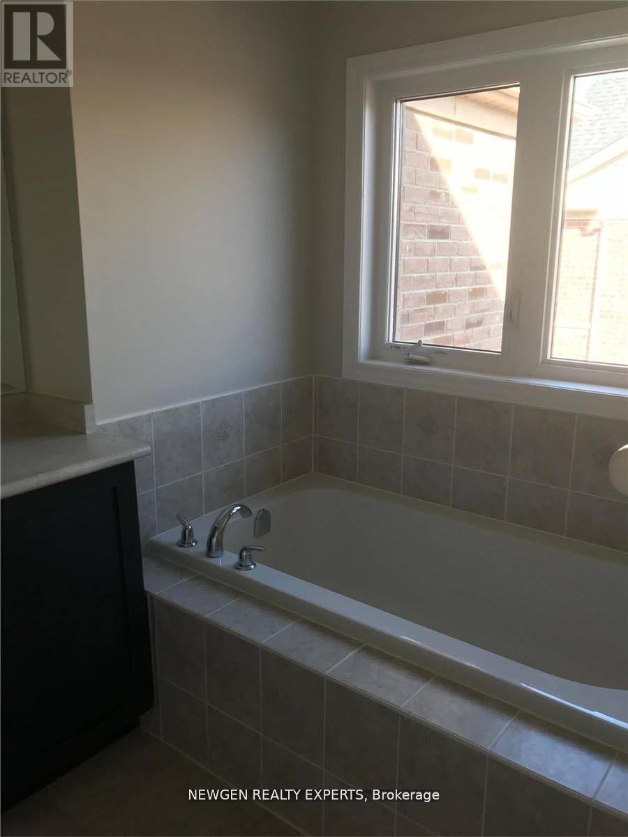 A bathroom with a tub and a window.