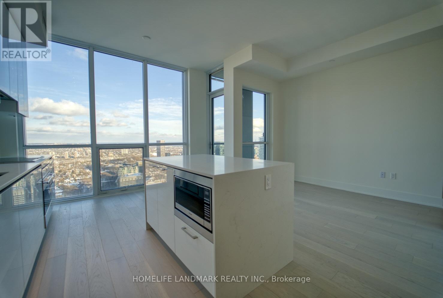 A modern kitchen with a view of the cityscape.