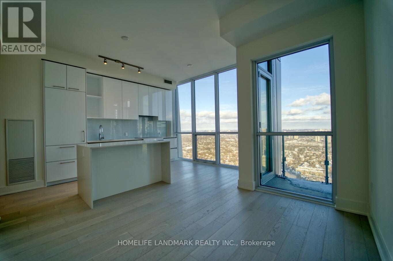 A spacious room with a view of the outdoors through large windows.