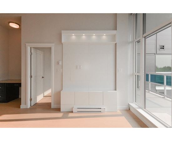 A white interior space with a large window and a white door.