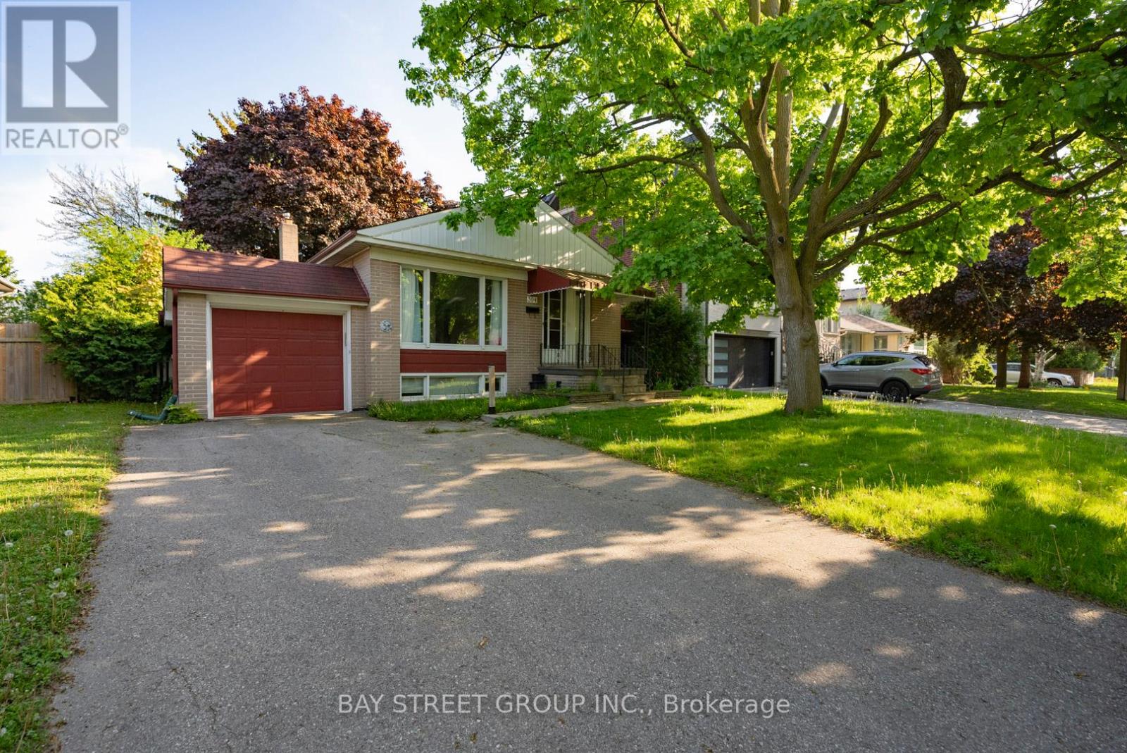 A house with a red garage door is for sale in Brokerage.