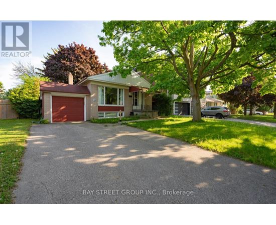 A house with a red garage door is for sale in Brokerage.