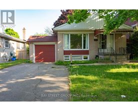 A house with a red garage door is for sale.