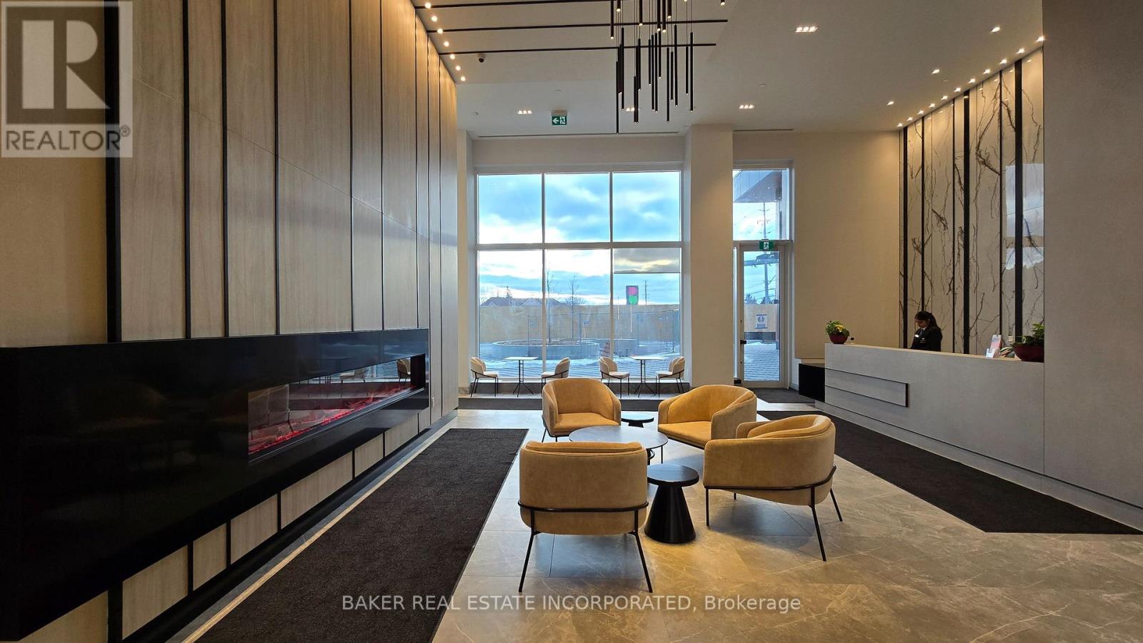 A realtor's office with a fireplace and a view of the mountains.