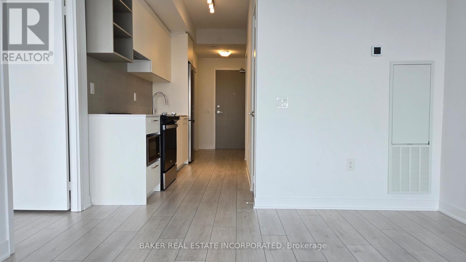 A real estate brokerage image of a kitchen and hallway.