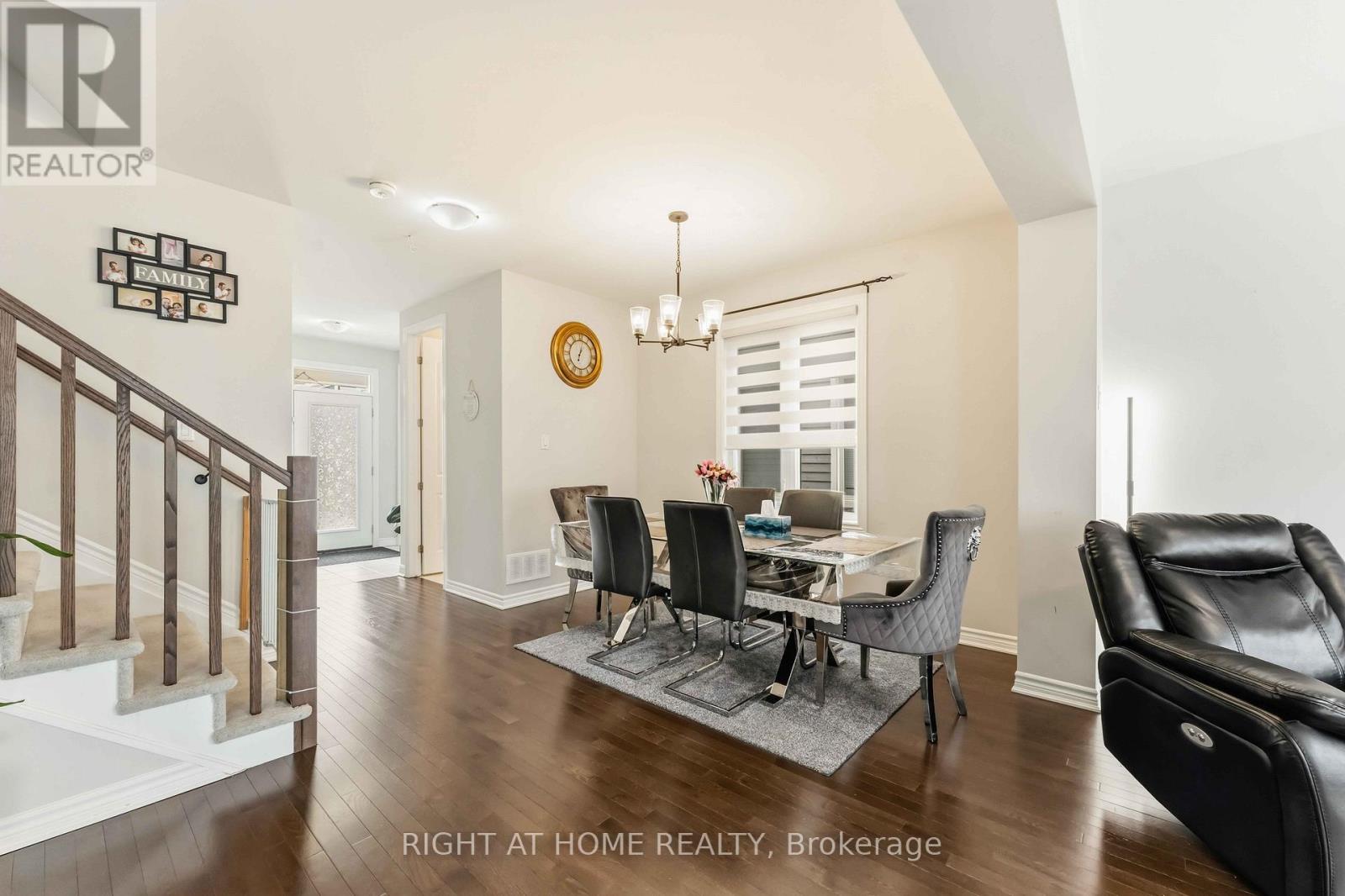 A well-lit dining room with a table set for four.
