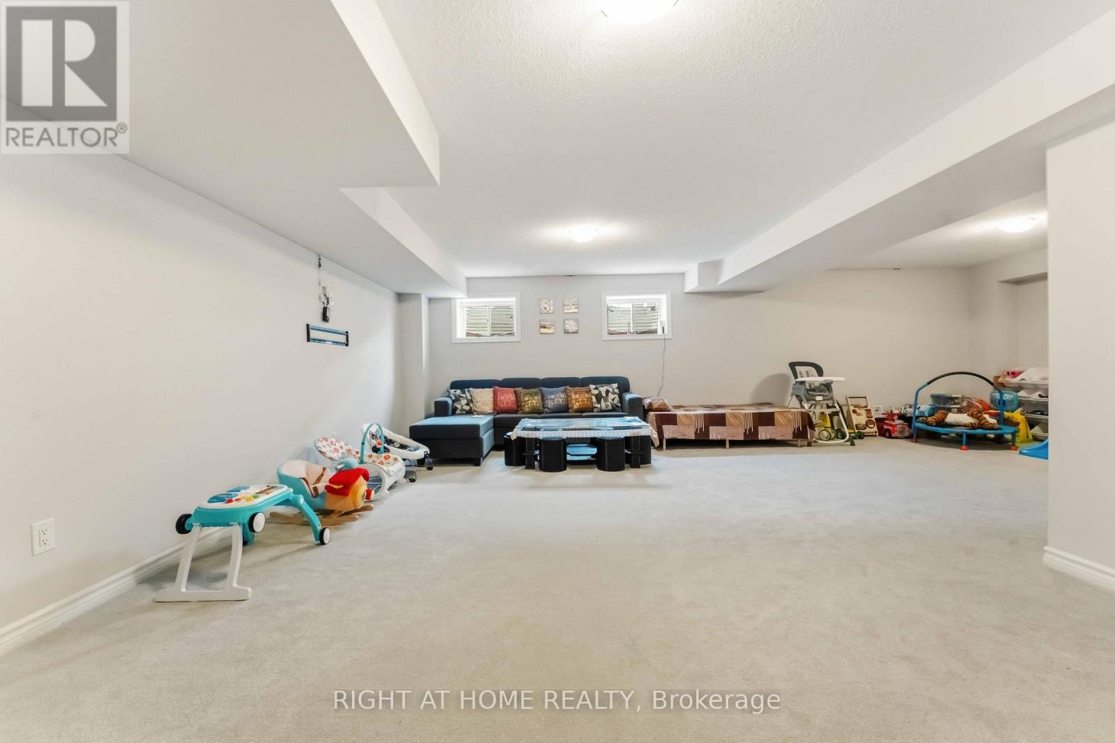 A sparsely furnished room with a large bed in the middle.