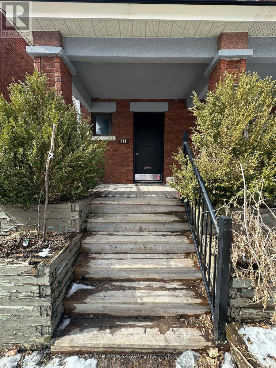 A set of stairs leading to a black door.