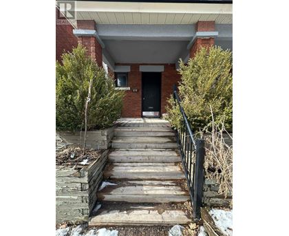 A set of stairs leading to a black door.