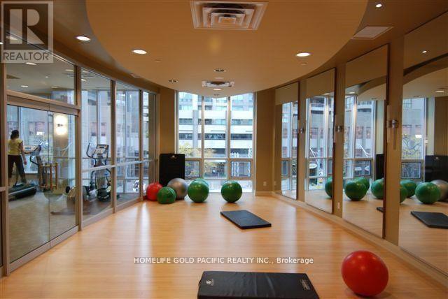 A gym with a mirrored wall and a sign that says REALTOR.