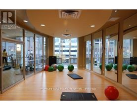 A gym with a mirrored wall and a sign that says REALTOR.