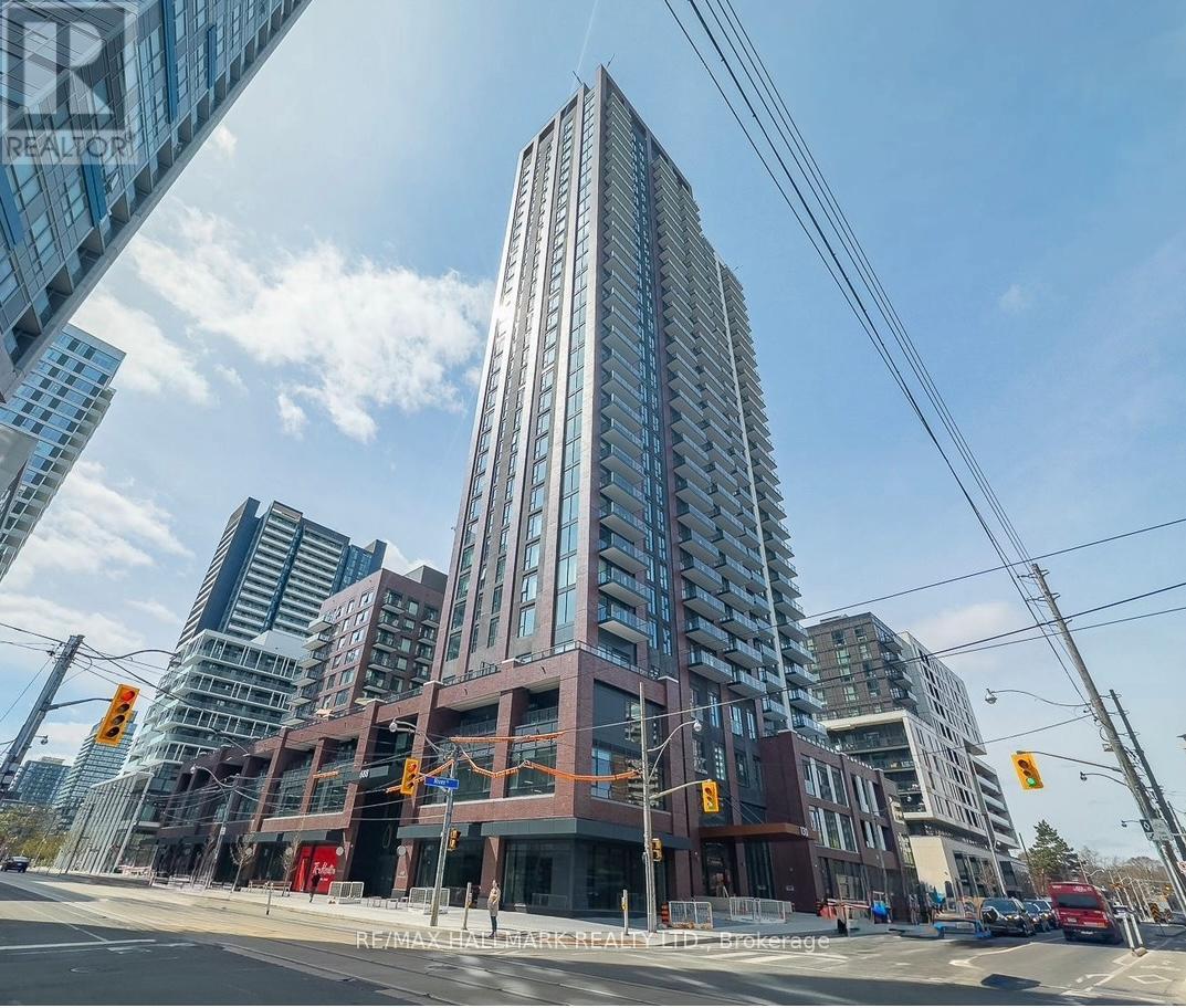 A tall building with many windows is under construction.