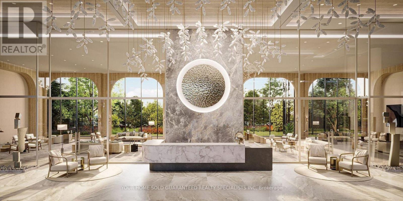 A modern interior space with a large circular sculpture in the center.