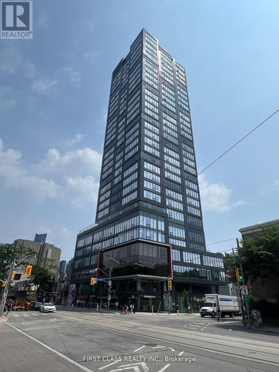 A tall building with many windows is the main focus of the image.