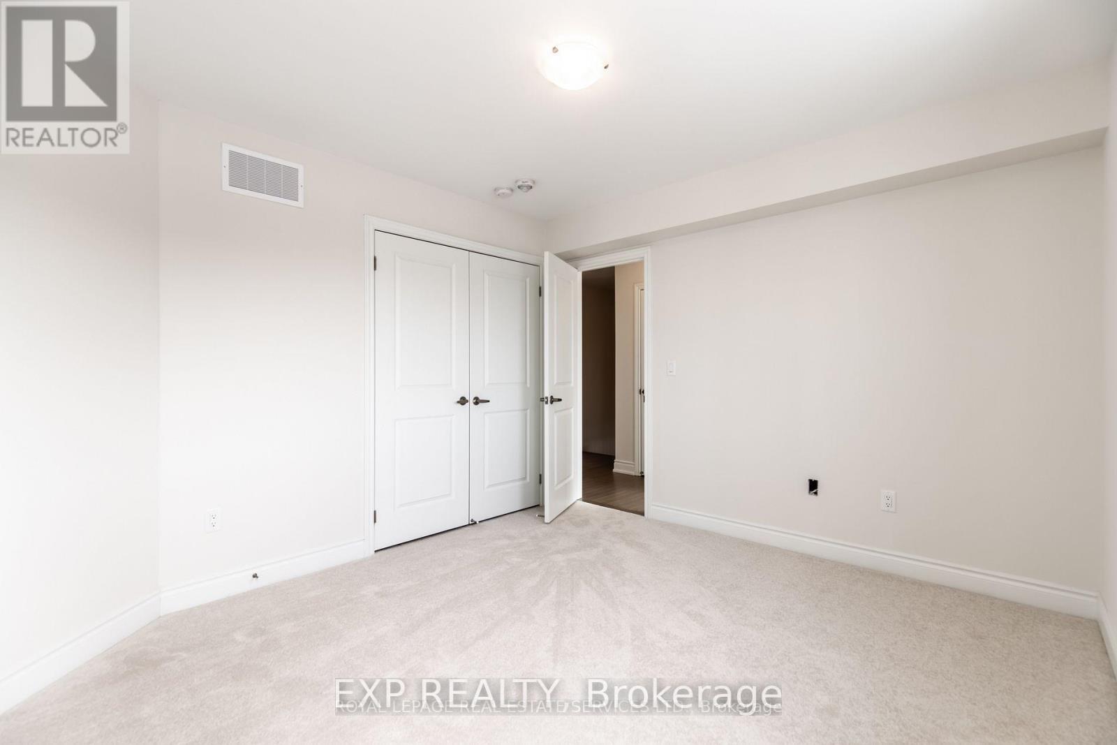 A white bedroom with a door and a window.