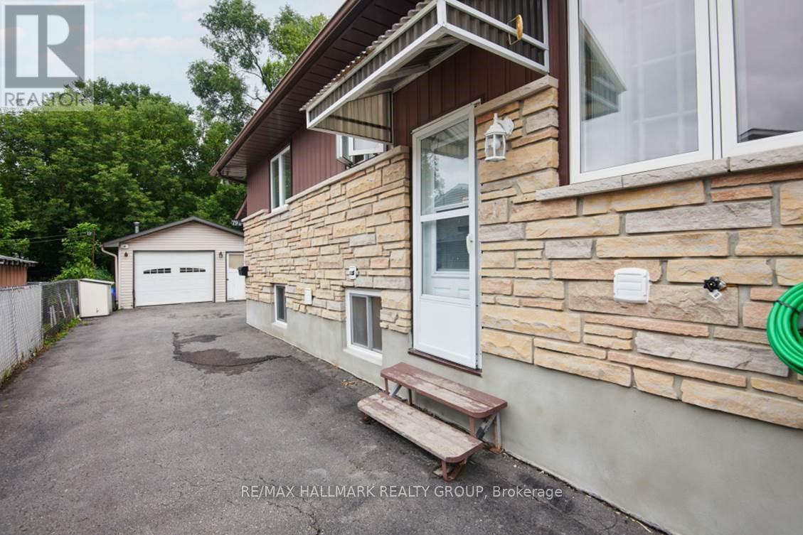 A house with a stone wall and a white door is for sale.