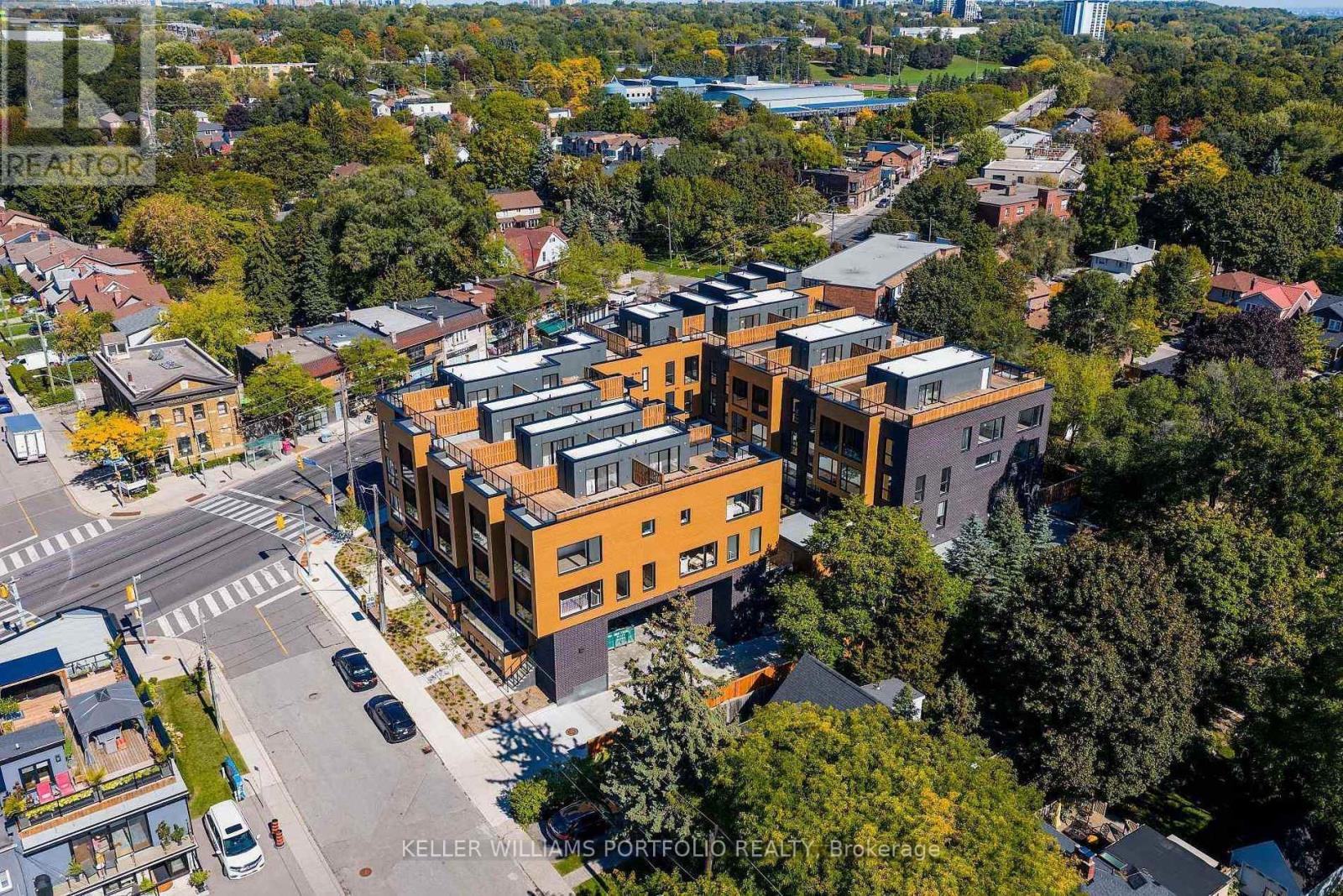 A real estate photographer has captured an aerial view of a modern apartment complex.