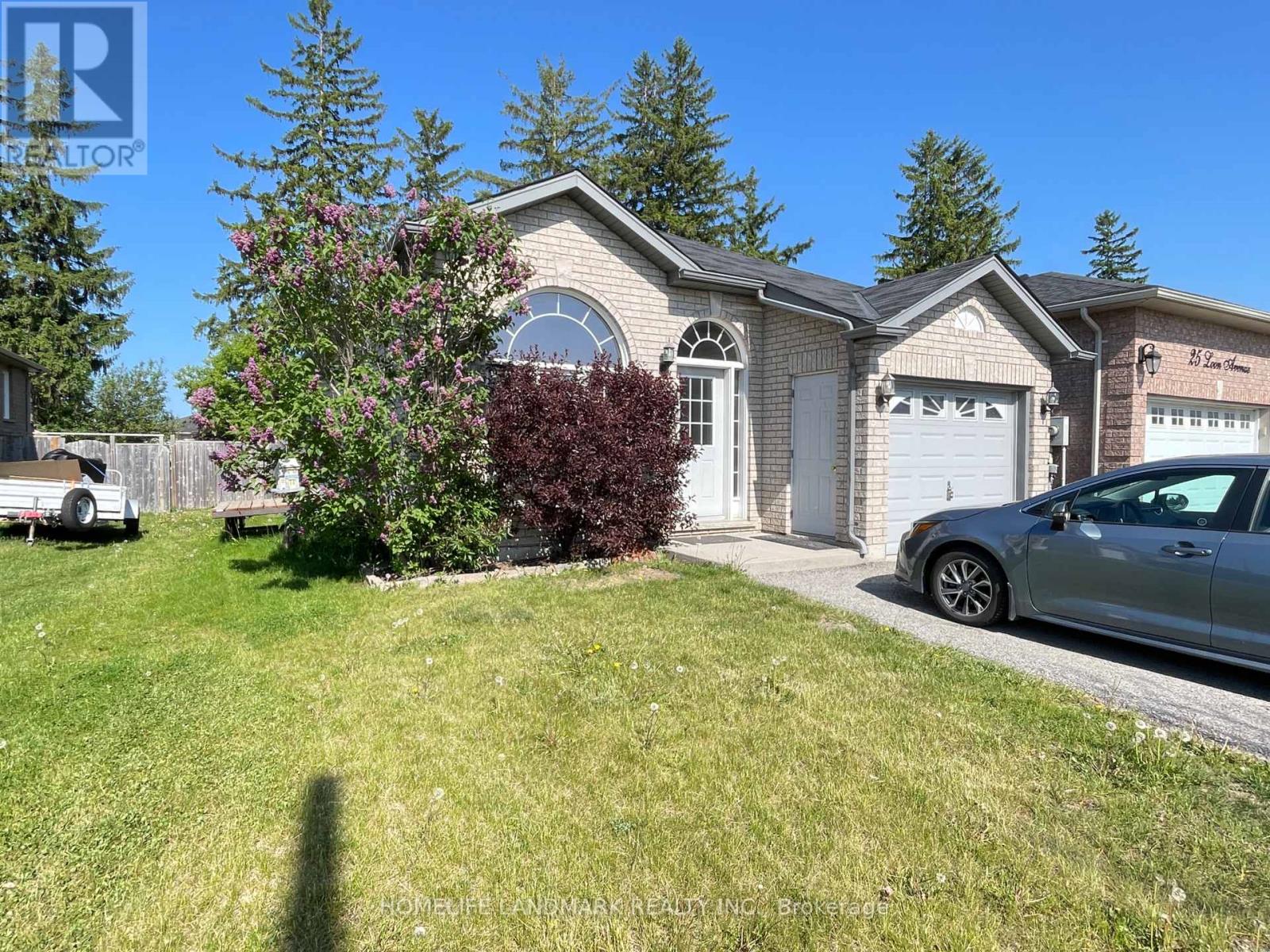 A house with a white garage door and a car parked in front.
