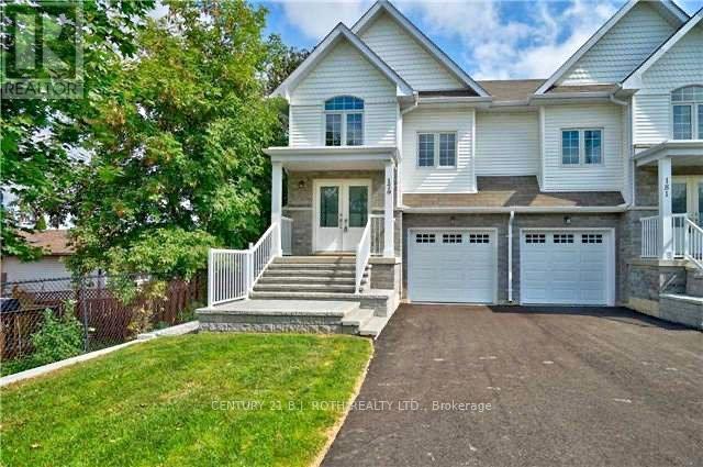 A two-story house with a garage is for sale.