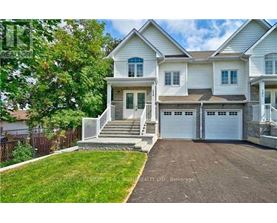 A two-story house with a garage is for sale.