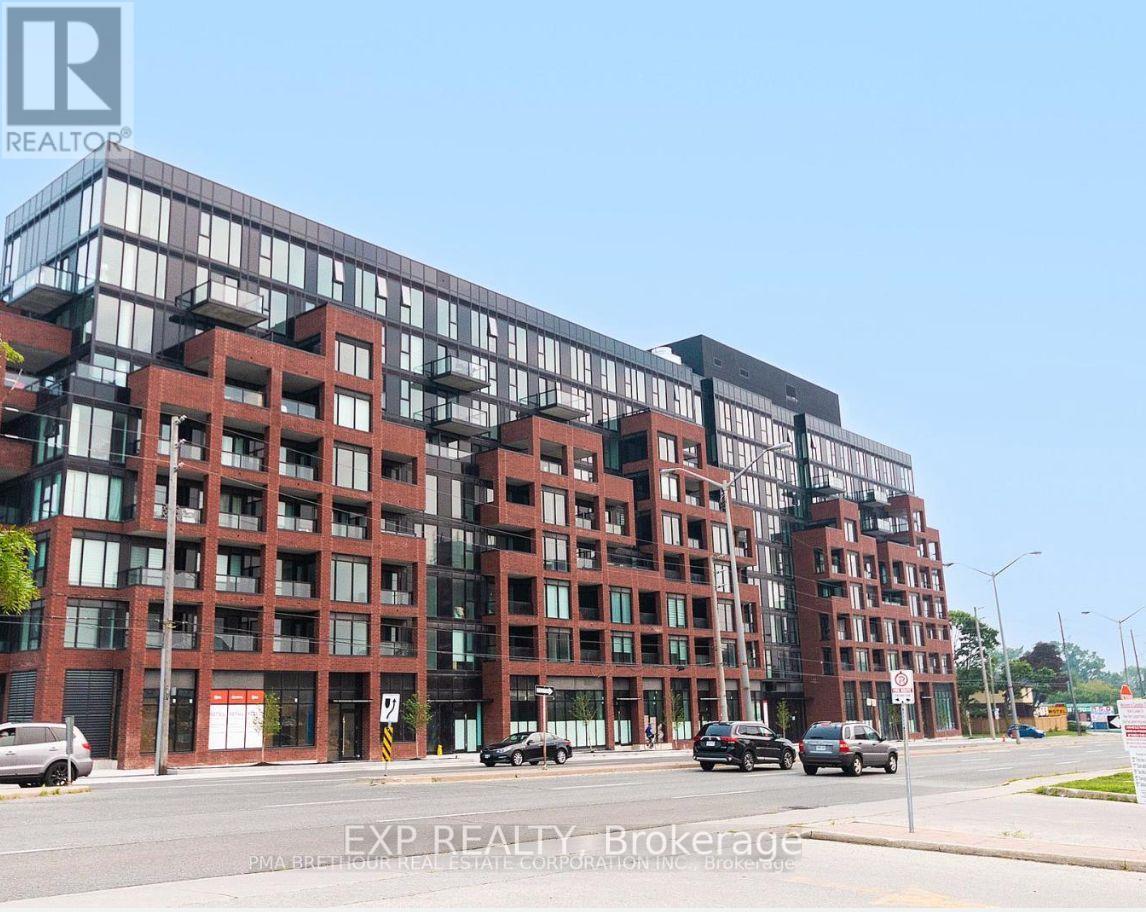 A large red brick building with multiple windows and balconies.