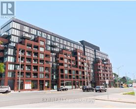 A large red brick building with multiple windows and balconies.