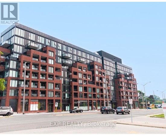 A large red brick building with multiple windows and balconies.