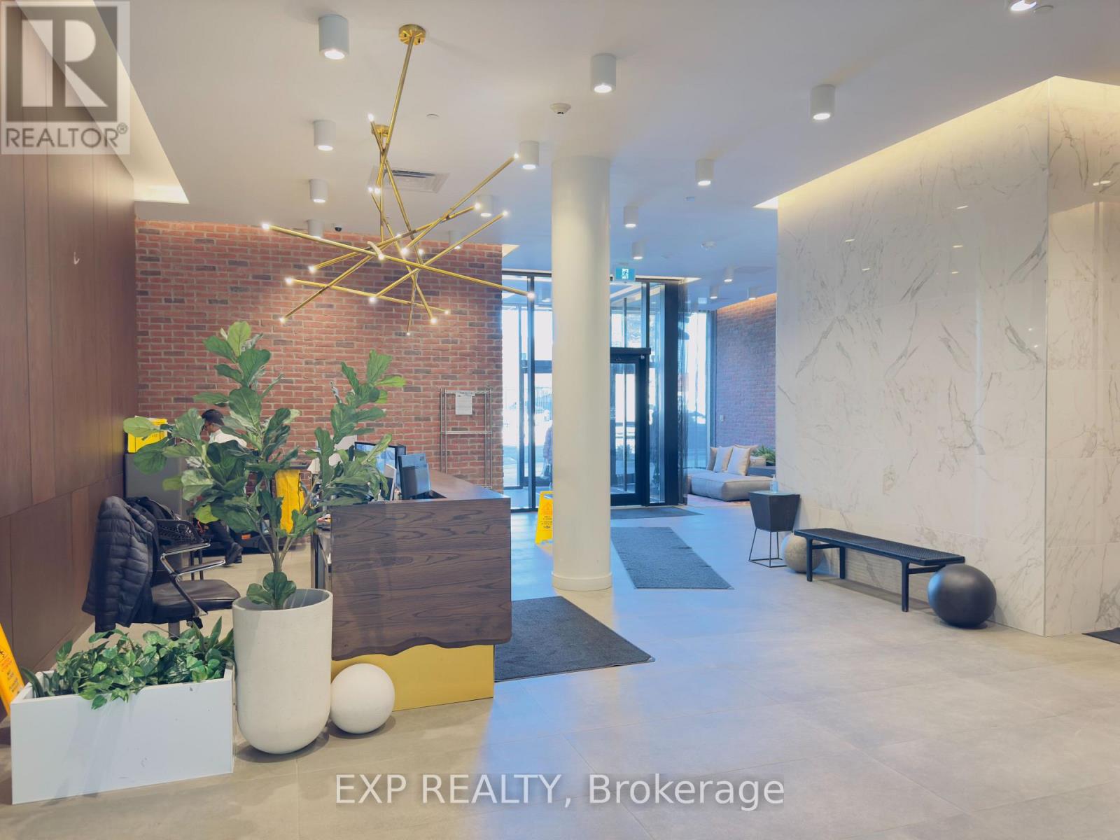 A reception area with a sign that says EXP REALTY, Brokerage.
