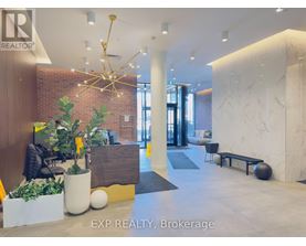 A reception area with a sign that says EXP REALTY, Brokerage.
