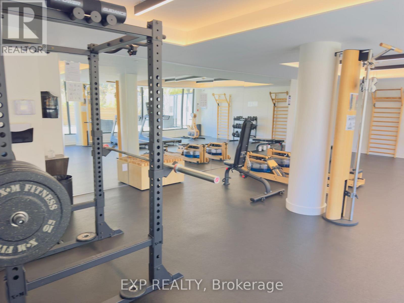 A gym with a weightlifting bar and weights.