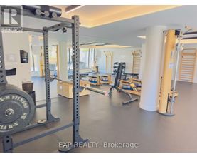 A gym with a weightlifting bar and weights.