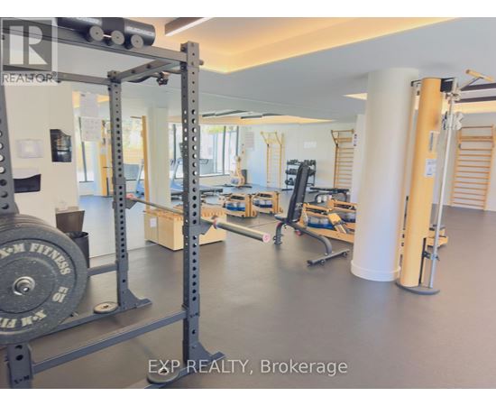 A gym with a weightlifting bar and weights.