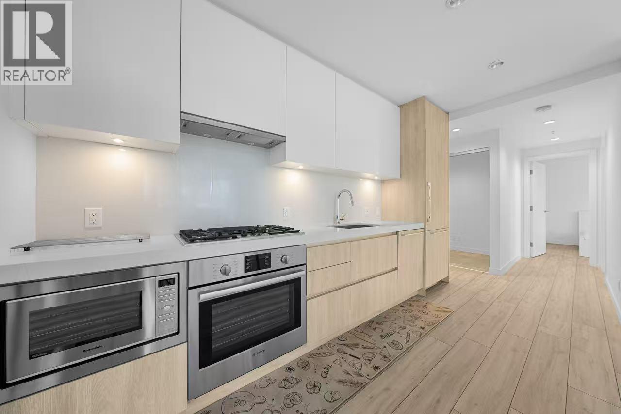 A modern kitchen with wooden cabinets and stainless steel appliances.
