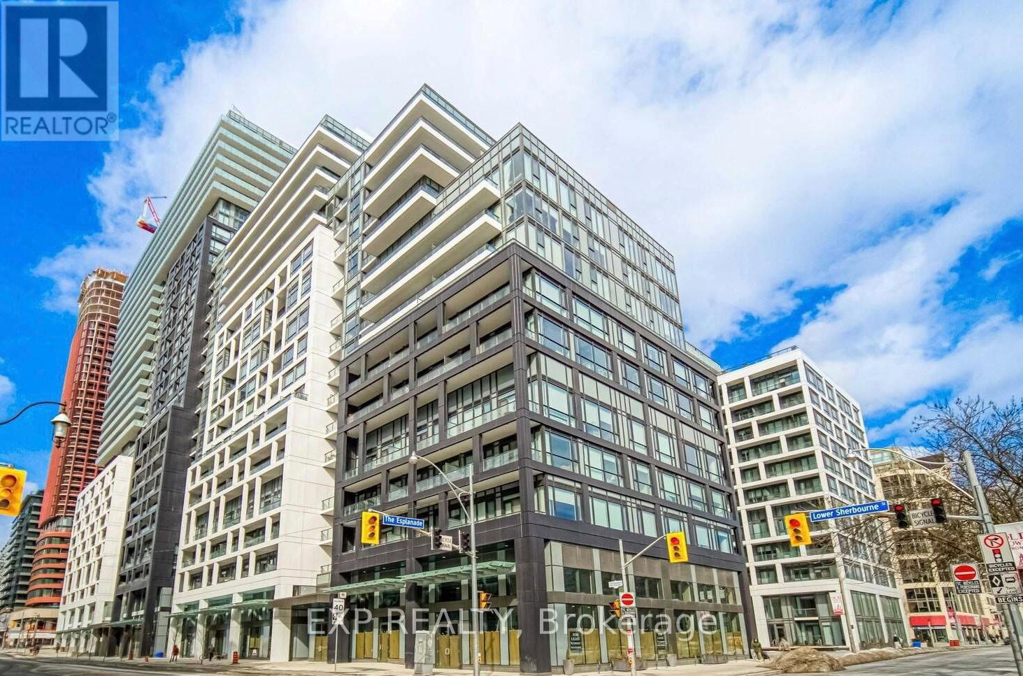 A modern multi-story building with a glass facade is the main focus of the image.