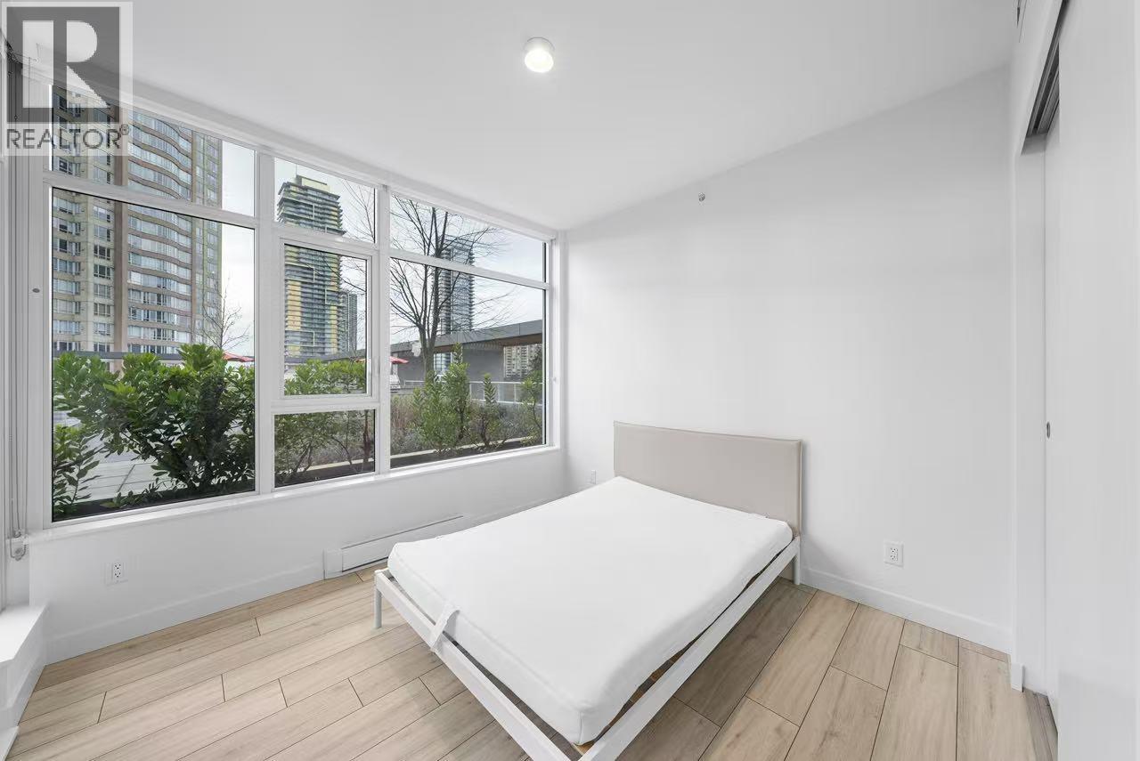A bedroom with a large bed and a view of the city.