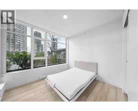 A bedroom with a large bed and a view of the city.