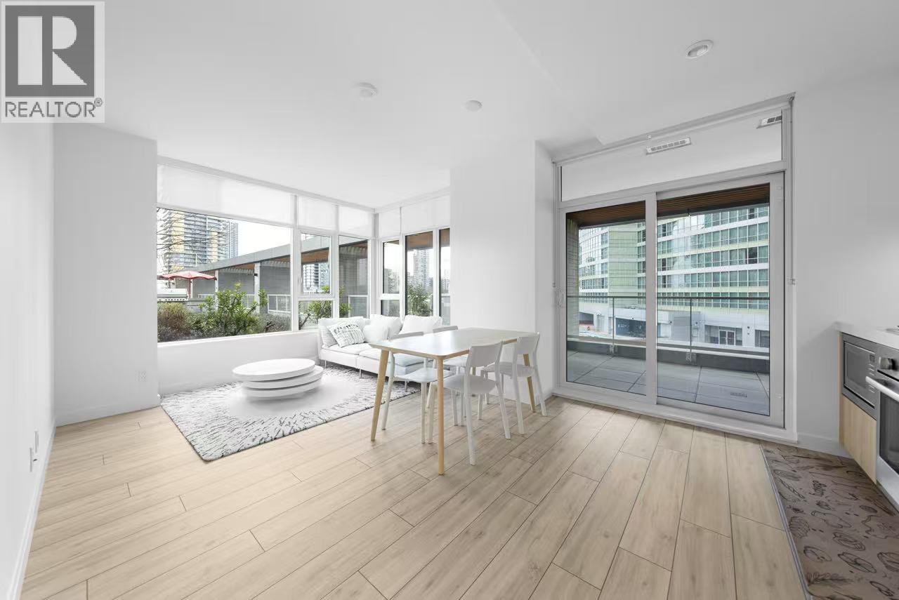 A modern living room with a dining table and chairs.