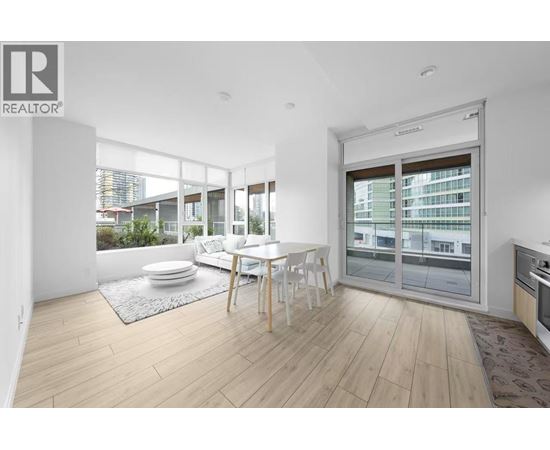 A modern living room with a dining table and chairs.