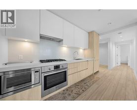 A modern kitchen with wooden cabinets and stainless steel appliances.