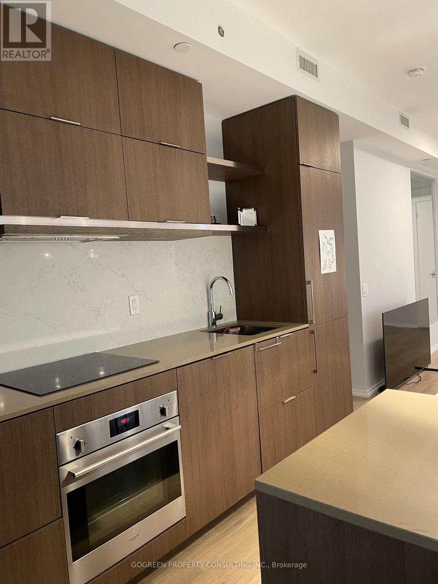A modern kitchen with wooden cabinets and stainless steel appliances.
