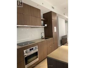A modern kitchen with wooden cabinets and stainless steel appliances.