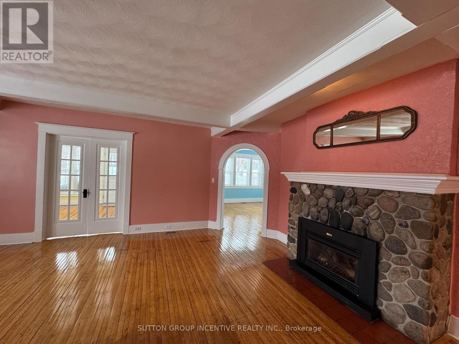 A room with a fireplace and a stone mantle.