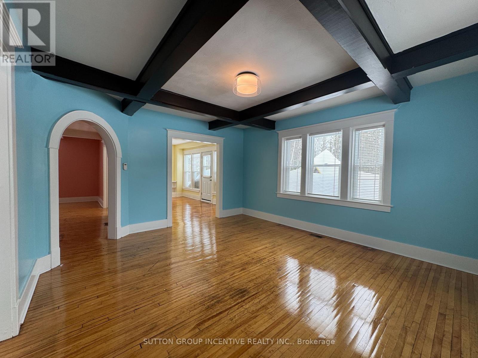 A room with blue walls and wooden floors.