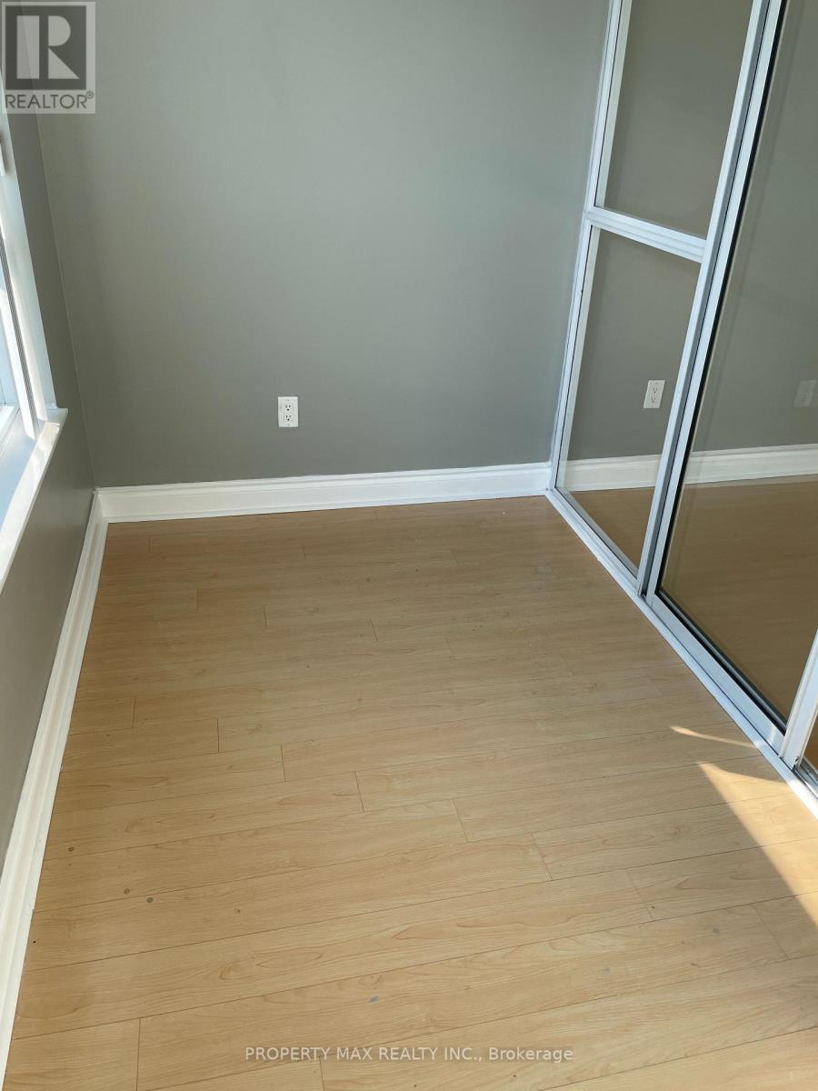 A room with wooden flooring and a glass door.