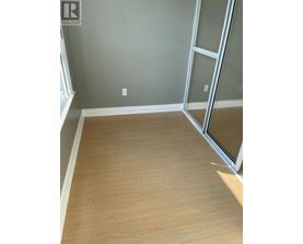 A room with wooden flooring and a glass door.