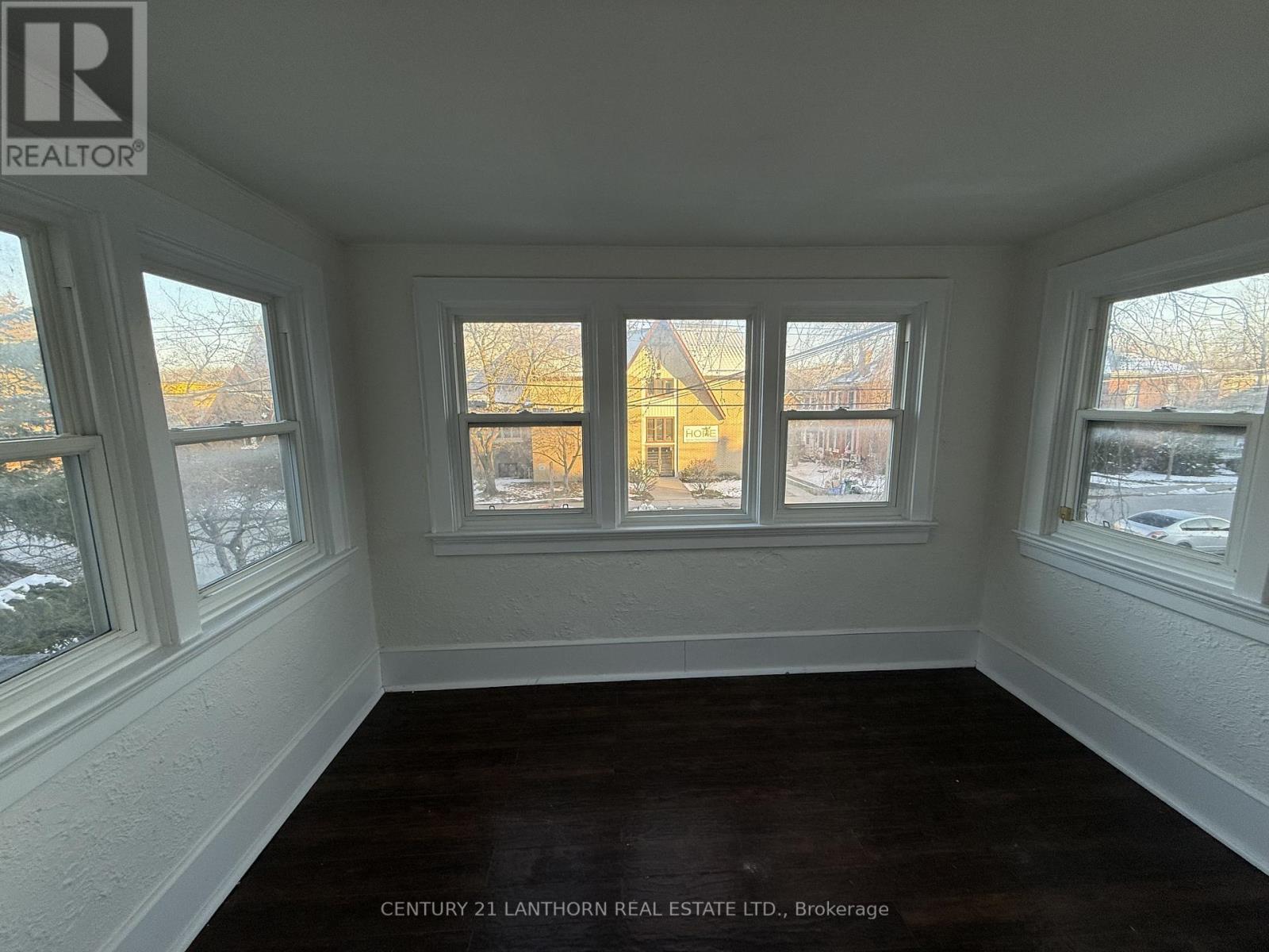 A room with a window showing a view of a building outside.