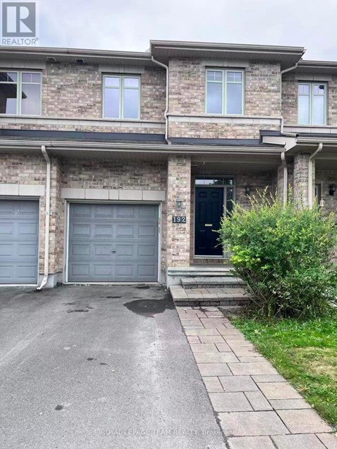 A house with a black door and a garage door.