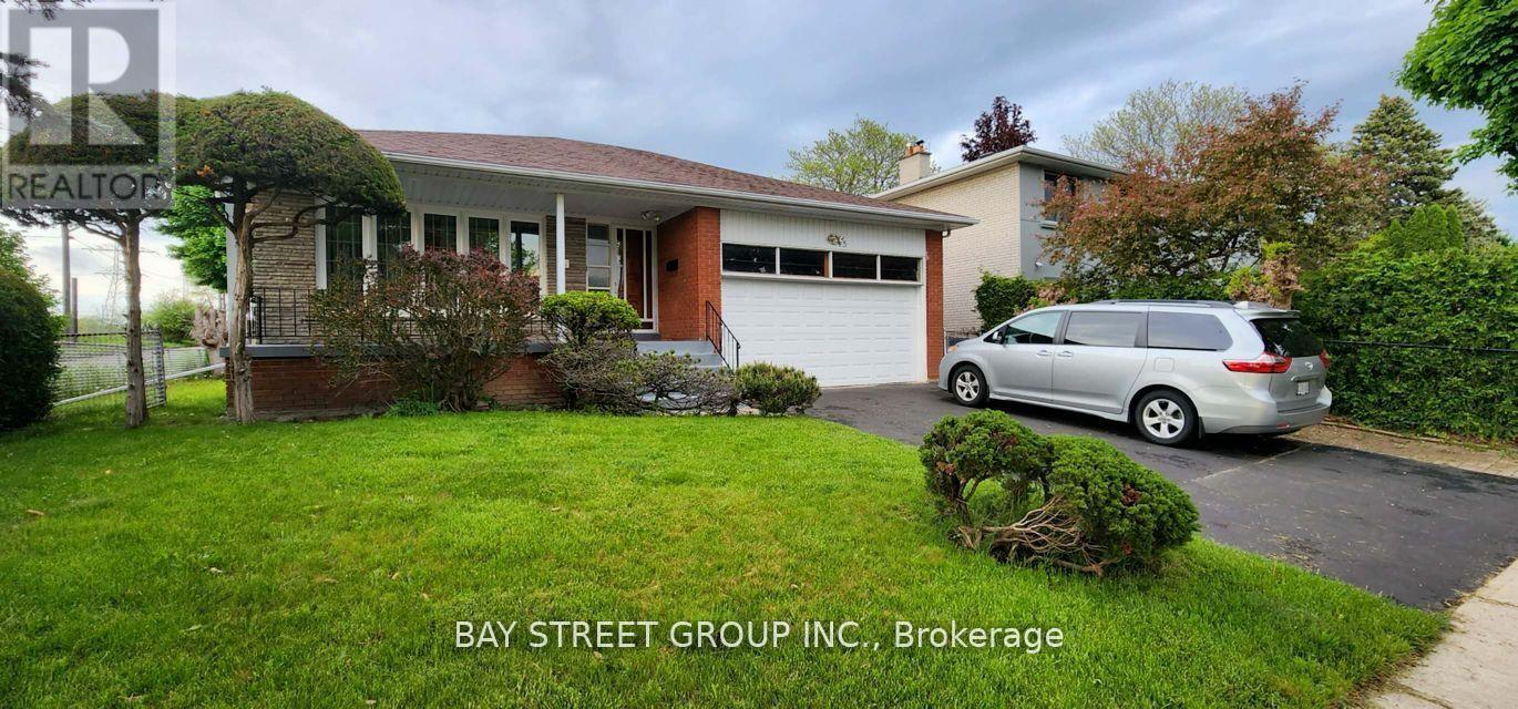 A Bay Street Group Inc. brokerage sign is displayed in front of a house.