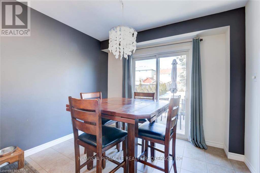 A dining room with a wooden table and chairs.